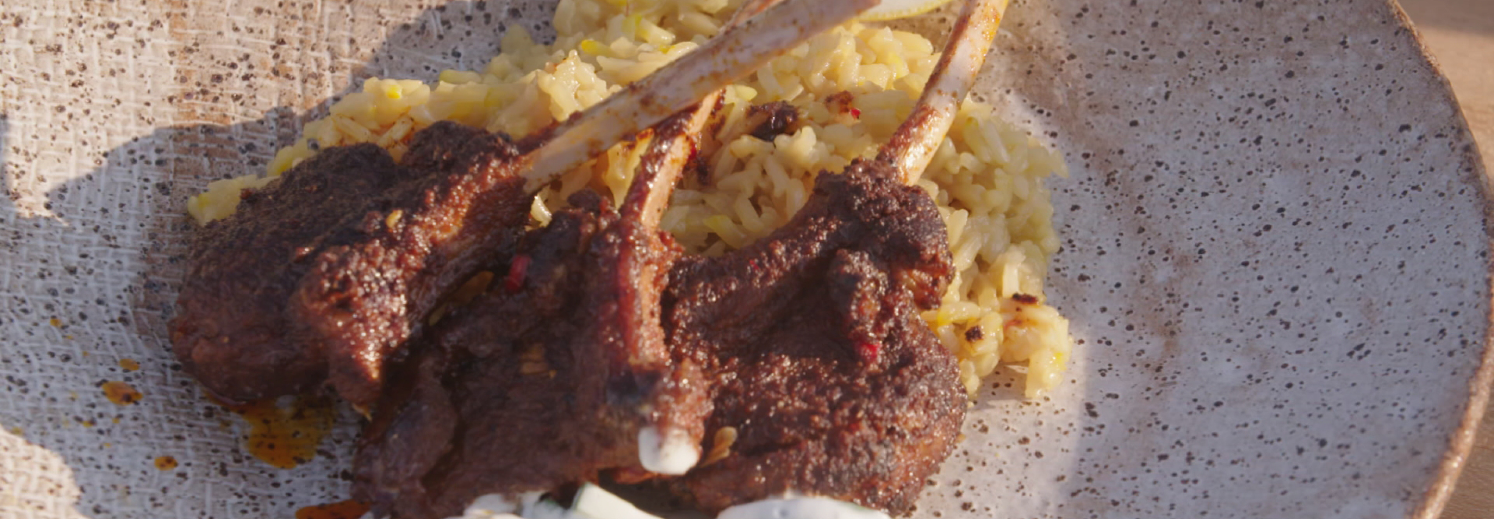 Lamb on the bone on top of a bed of rice